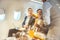 On a corporate aircraft, an air hostess serves passengers. On an airplane, a flight attendant serves a drink to a businessman who