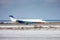 Corporate aircraft taxiing on the runway in a cold winter airport