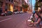 Corporate buildings, city bicycles and people on Mansfield street at sundown in Montreal, Canada