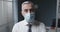 Corporate businessman wearing a surgical mask