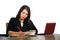 Corporate company portrait of young beautiful and busy Asian Chinese businesswoman working at office computer desk concentrated in