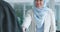 Corporate islamic woman, handshake or agreement for success, smile or happy in office for interview. Muslim seo expert