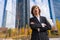 Corporate portrait of an alternative businessman in a business park with arms crossed