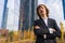 Corporate portrait of alternative businessman in a business park with arms crossed