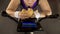 Corpulent female eating fatty burger while riding stationary bike, fast food