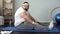 Corpulent man sitting on mat for exercising, labored breathing, obesity problems