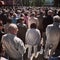 Corpus Christi Day. Crowd people during procession. Artistic look in vintage vivid colours.