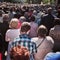 Corpus Christi Day. Crowd people during procession. Artistic look in vintage vivid colours.