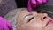 correction and shaping of women's eyebrows in a beauty salon. eyebrow threading