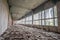 Corridor of an abandoned Soviet building of the 80s with crumbling cladding