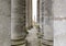 Corridor of ancient columns. A secret passage, two long rows of ancient stone columns everywhere, a tunnel. Rows of columns. Archi