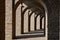 Corridor between brick pathway under arch brick structure of ancient roman amphitheater.