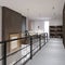 The corridor with glass railings on the second floor, leading to a recreation area and a library. Duplex apartment in the style of