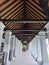 the corridor of a hotel looks beautiful teak wood and charming pillars