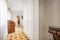 Corridor of a house with a beautiful wooden parquet floor in various shades and built-in wardrobes with white lacquered wooden