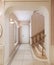 Corridor with a mirror and a staircase to the second floor in a