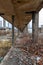 Corridor of an old chemical factory looted dilapidated crumbling bricks gravel concrete