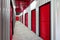 Corridor of self storage unit with red doors. Rental Storage Units