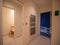 Corridors with white walls, a towel warmer, access to the hammam with an open glass door