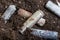 A corroded battery is lying on the ground. Environmental protection and waste recycling. Close-up shot