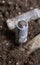 A corroded battery is lying on the ground. Environmental protection and waste recycling. Close-up shot