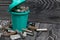Corroded used batteries. They lie in and around the trash can. Disposal of hazardous waste