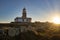 Corrubedo lighthouse surrounded by rocks and grass under the sunlight in Spain