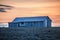 Corrugated iron hut at sunset