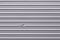 Corrugated metallic surface with dent