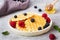 Corrugated waffle cookies with fresh raspberries and blueberries on a concrete background. Copy space.