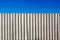 Corrugated white metal fence