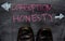 Corruption or Honesty written with color chalk concept on the blackboard