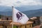 Corsican flag in front of houses and mountains in Central Corsica