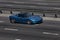 Corvette blue speeding on empty highway