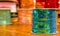Cose up of shiny rolls of colorful sequins green tape, multi-colored over a wooden table in a blurred background