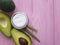cosmetic avocado cream on pink wood