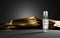 Cosmetic beauty product for men skin care on dark background with gold silk fabric. Glass spray transparent bottle