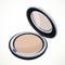 Cosmetic beige powder isolated on a white