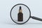 Cosmetic bottle behind magnifying glass