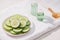 Cosmetic bottle and fresh organic cucumber for skincare. Home spa concept