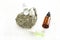 Cosmetic bottles with pipette with essential oil in different jars, natural stone and flowers on a white background. Alternative