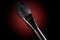 Cosmetic brush for a make-up close up on a dark, red background