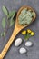 Cosmetic clay and flower and branch of eucalyptus, stones, for spa treatments, in wooden spoon, slate background