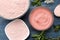 Cosmetic clay. Pink cosmetic clay in different types on a blue wooden table. face mask and body. care products. spa. top view