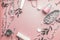 Cosmetic concept. Facial skin care products and paper shopping bag on pastel pink background with cherry blossom and leaves, top