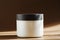 Cosmetic cream, balm jar mockup on brown background. Makeup product blank container. Body care cosmetics, cleaning scrub in modern