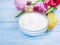 Cosmetic cream moisturizer ointment treatment , flower tulip rustic on blue wooden background