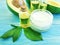 Cosmetic cream, oil, vitamin avocado health on a wooden background