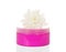 Cosmetic cream in pink container and flower