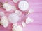Cosmetic cream, rose flower, accessories salt on a pink wooden background